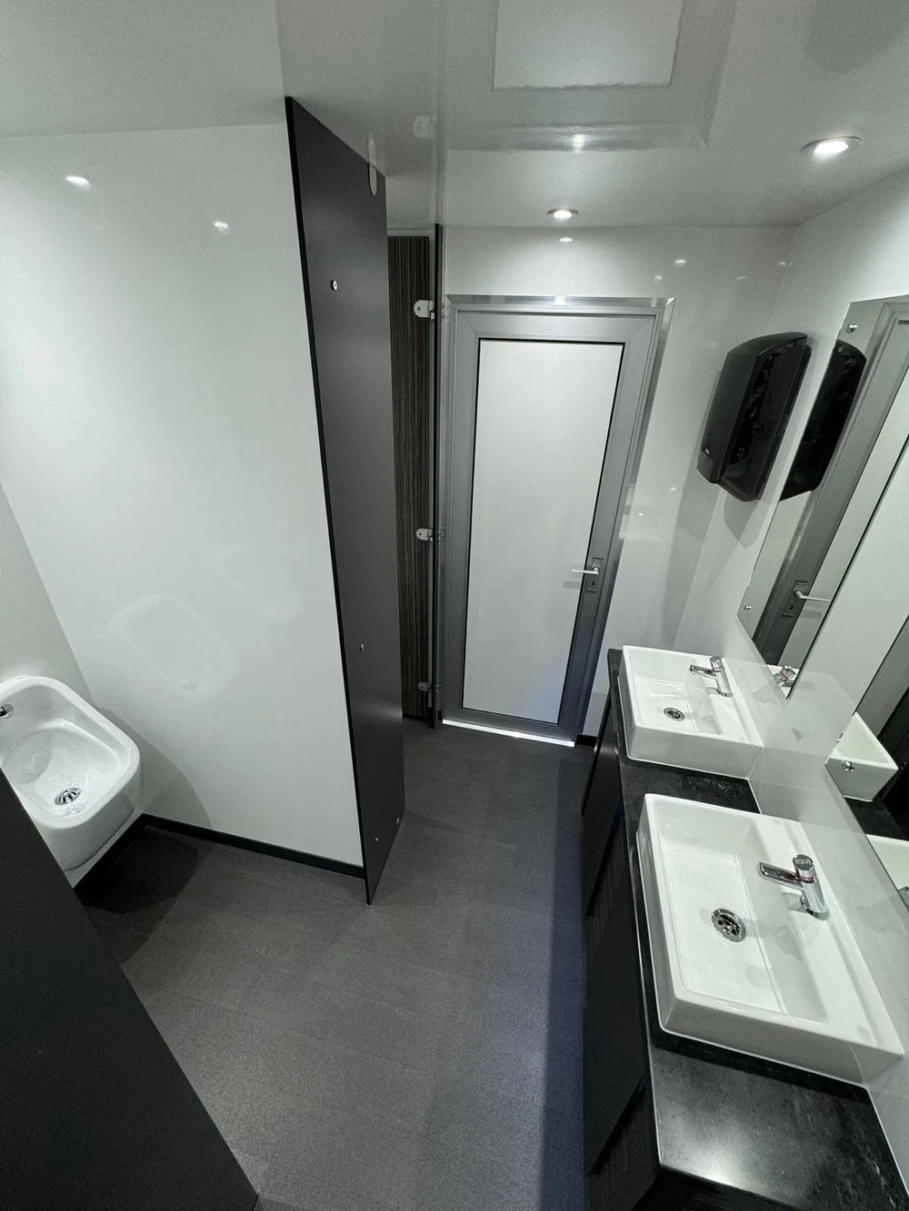 Gents urinals with walnut door in luxury wedding toilet trailer for Berkshire weddings